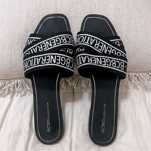 BCBGeneration Logo Crossover Flat Sandal in Black Size-9.5